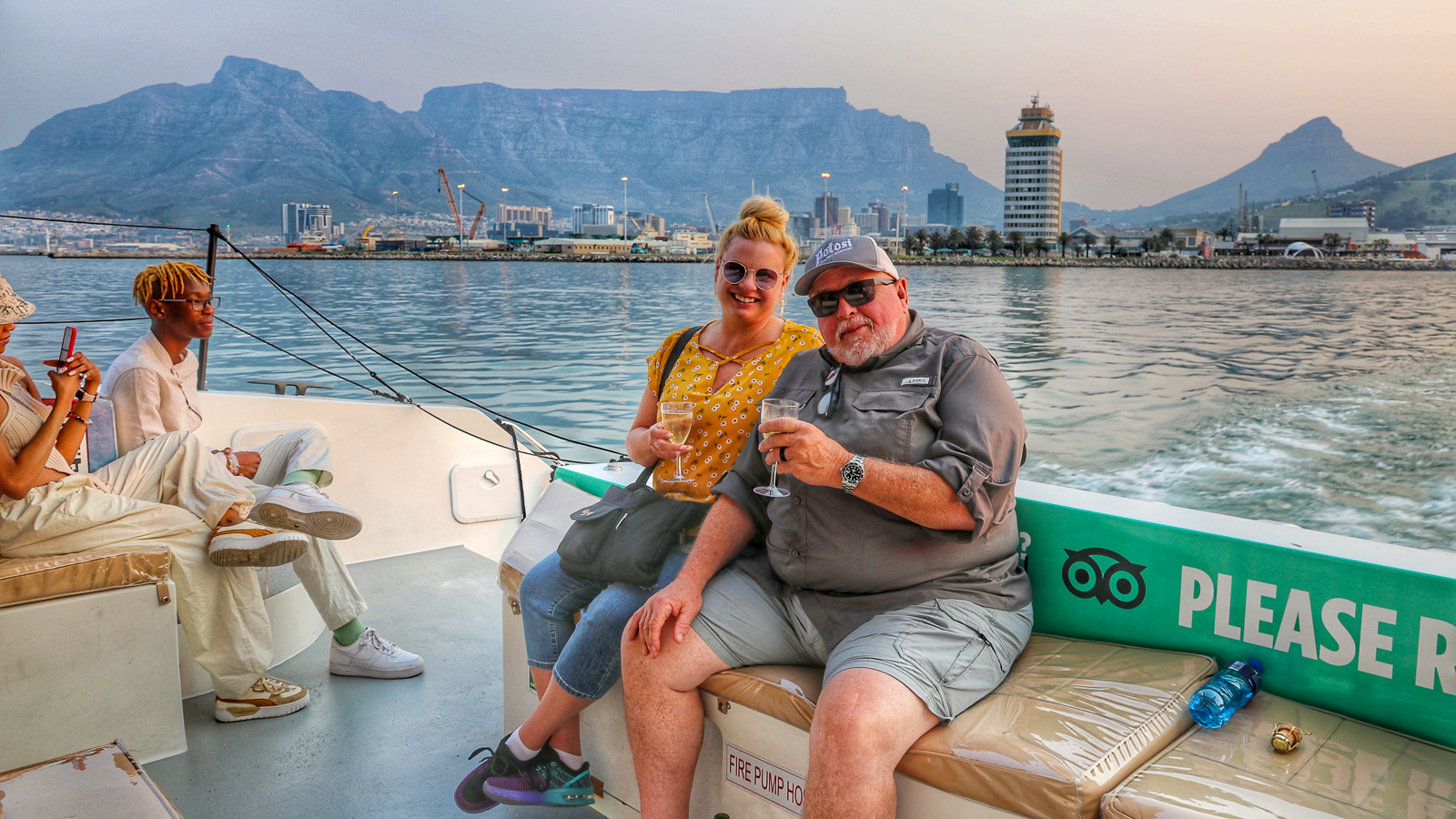 Cape Town Tour - Couple enjoying a beautiful sunset cruise around the Waterfront Harbour.